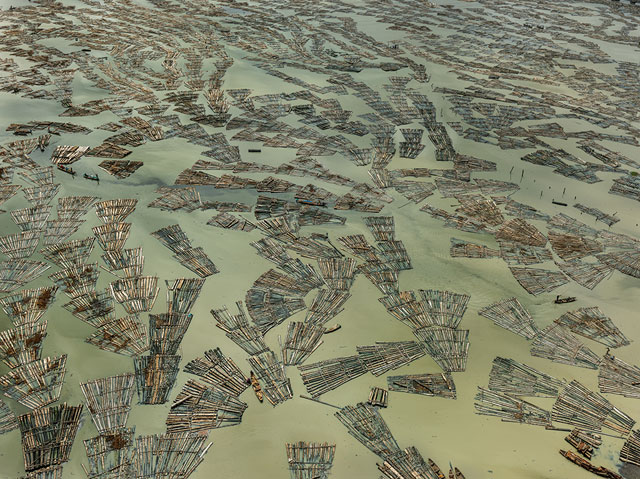 Edward Burtynsky. Saw Mills #3, Log Booms, Lagos, Nigeria 2016. Courtesy Flowers Gallery, London and Metivier Gallery, Toronto,