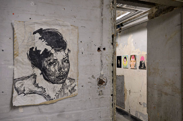 Tamsyn Challenger, 400 Women, 2010. Portraits by various artists. Installation view, Shoreditch Town Hall Basement, London, 2010. Central image by Swoon. Photograph: Paul Tucker.