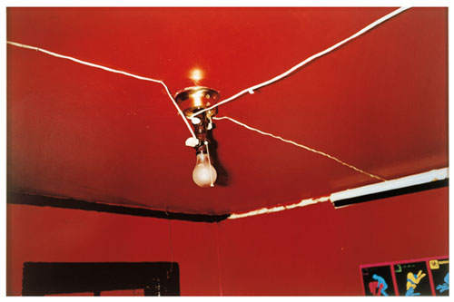 William Eggleston. The Red Ceiling, Greenwood, Mississippi, 1973. Dye transfer print, 35.2 × 55.1 cm (13.9 in × 21.7 in). Getty Center; Museum of Modern Art. © Eggleston Artistic Trust.