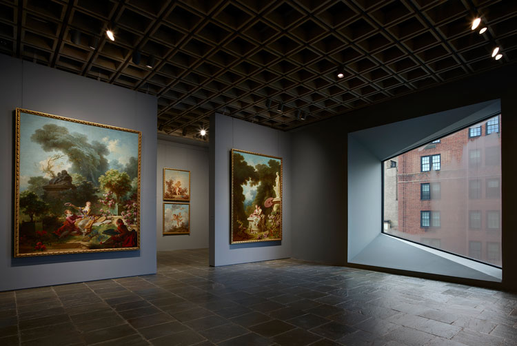 Room 24: Four grand panels of Fragonard’s series The Progress of Love are shown together at Frick Madison in a gallery illuminated by one of Marcel Breuer’s trapezoidal windows. This view shows two of the 1771–72 paintings, with two later overdoors visible in the next gallery. Photo: Joe Coscia, courtesy The Frick Collection.
