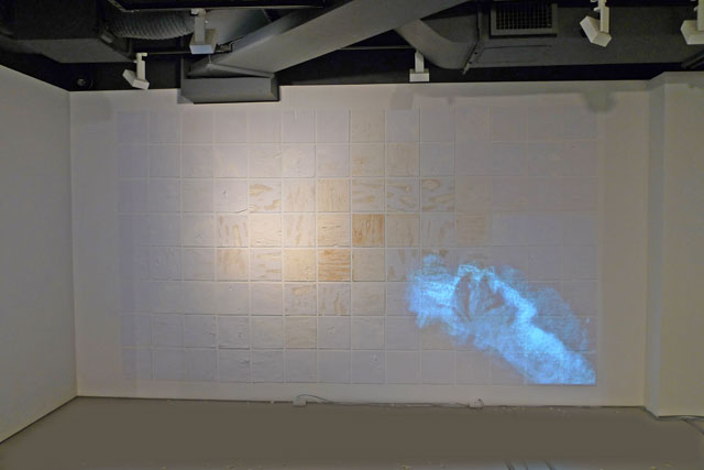Birgitta Hosea. Scrubbed Clean, 2018. Bleach, Cif, bicarbonate of soda and flour on paper with projected animation, 260 x 470 cm. Installation view.