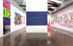 Irene Barberis. Installation view: Apocalypse/Revelation: Re Looking (Feminale; the edge of logic, intersecting luminosities).

Centre: Writings on the Wall (on canvas) #7, (Revelation Chapters 16 -22), 2012. Primed canvas, acrylic housepaint, white marker and chalk pen, 1.4 x 3 m.

Right: Cut it Out! Its a Wonderful World; Resurrection in Melbourne2012 (after Stanley Spencer), 2012. Laser cut acrylic with coloured mapping pins.

Photograph: Mark Ashkanasy.