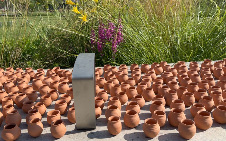 Risham Syed, Each Tiny Drop, Mayfield Park, Manchester International Festival 2023. Unfired terracotta pots. Photo: Martin Kennedy.