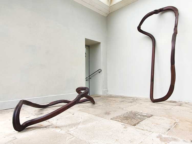 Nika Neelova. Left: Lemniscate X, 2020. Hardwood reclaimed handrails, two flights of stairs, 50 x 210 x 120 cm. Right: Lemniscate XI/II, 2021. Hardwood reclaimed handrails, two flights of stairs, 280 x 130 x 60 cm. Installation view, One of Many Fragments, New Art Centre, Roche Court, Salisbury 2021.