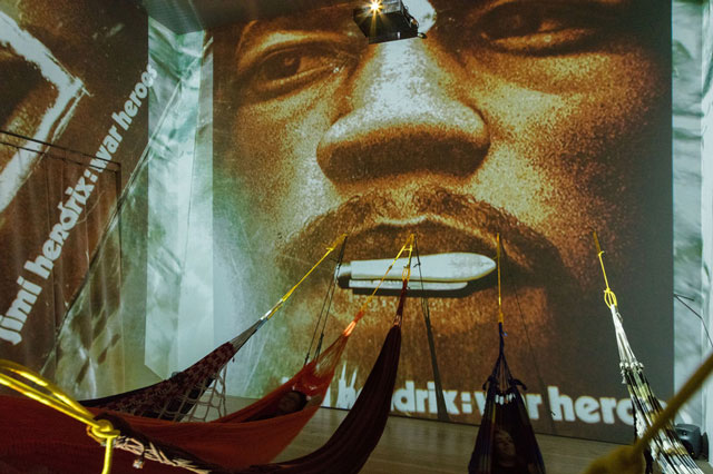 Hélio Oiticica. Installation view. CC5 Hendrix-War, 1973. Thirty-three 35mm colour slides transferred to digital slideshow, sound, and hammocks. Site Specific Collections of César and Claudio Oiticica and Neville D’Almeida. Whitney Museum of American Art, New York, N.Y. Photograph by Oto Gillen.