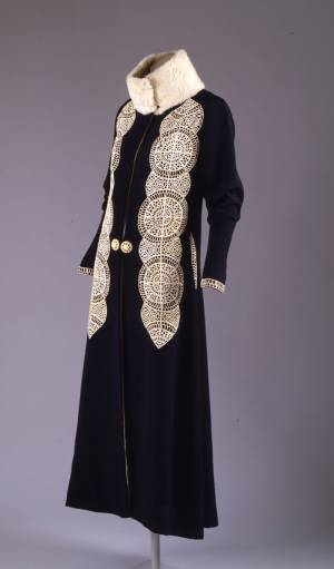 Paul Poiret (French, 1879&ndash;1944). Coat, ca. 1919. Black silk and wool rep weave with white kid cutwork appliqu&eacute; and white broadtail&nbsp;trim. The Metropolitan Museum of Art, Gift of Mrs. David J. Colton, 1961