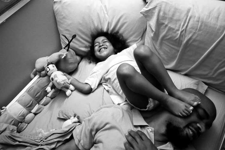 Zun Lee. Bedtime shenanigans with Carlos Richardson and his daughter, Selah. Harlem, NY, August 2012 (from the project, Father Figure, 2011-15), 2012. Copyright Zun Lee. All rights reserved.