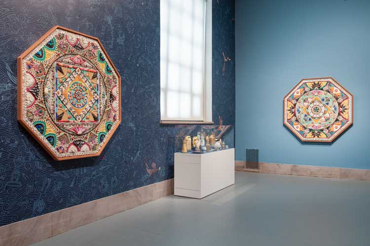 DEATH TO THE LIVING, Long Live Trash, installation view. Brooklyn Museum, 2022-23. Left: Sailor’s Valentine: Duke Riley, Order Here Prescription History, 2019, found plastic mosaic on panel, 168.9 × 168.9 × 10.2 cm, courtesy of the artist; Right: Sailor’s Valentine: Duke Riley, I am Delicious, Come on Get Your Money’s Worth, 2020, found plastic mosaic on panel, 170 × 170 cm, courtesy of the artist. Photo: Danny Perez.