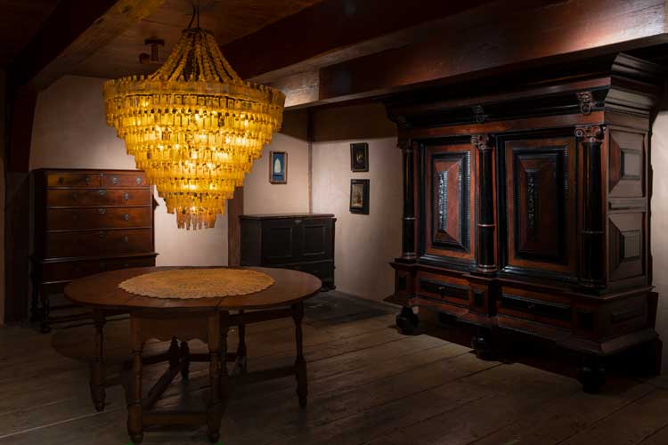 Décor à la Duke: doilies and Boozalier, a chandelier made from plastic liquor bottles. Photo: Danny Perez.