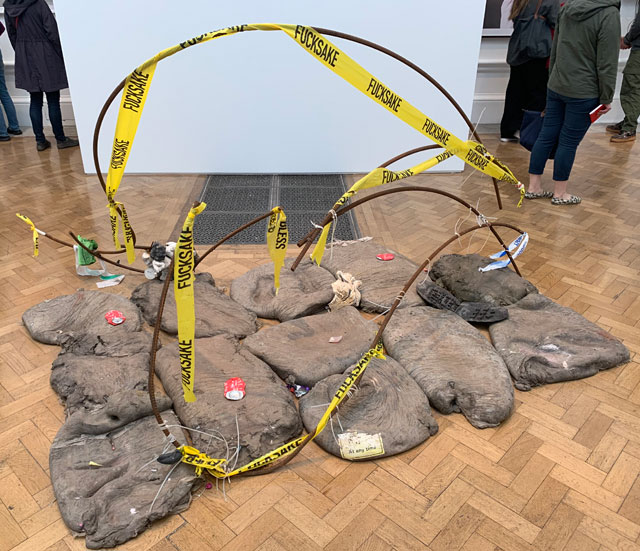 Michael Dean, (Unfucking Titled) Fucked Dove. Steel, concrete, cable ties, scene tape, cans and paperback publication, 175 x 300 x 150 cm. Installation view, Royal Academy of Arts. Photo: Martin Kennedy.