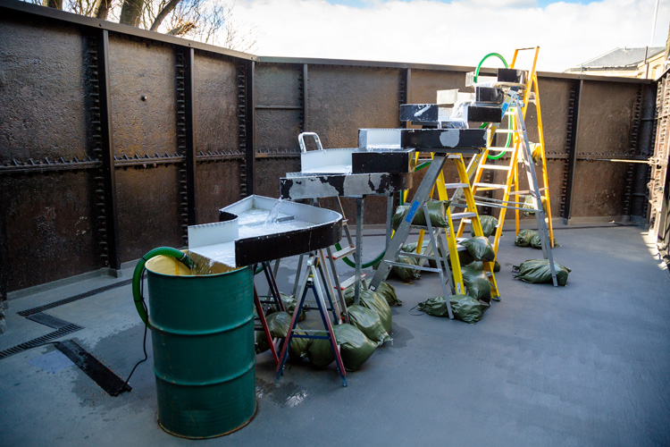 Virginia Overton, Untitled (cascade), 2020. Aluminium sign parts, ladders, steel drum, Uni-strut, water, pump, hose, sandbags and hardware. Commissioned by Goldsmiths Centre for Contemporary Art, London. Courtesy of the artist and White Cube. Photo: Mark Blower.